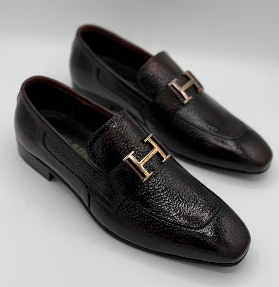 dark brown or burgundy pebble-grain leather H buckle